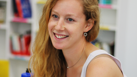 Portrait of Leah Reis-Dennis smiling.