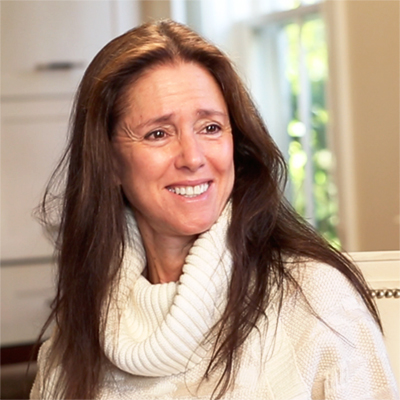 Portrait of Julie Taymor smiling.