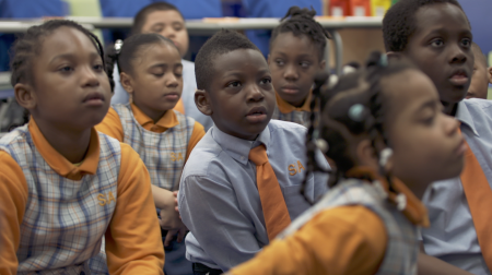 A group of young students focusing ahead in success academy