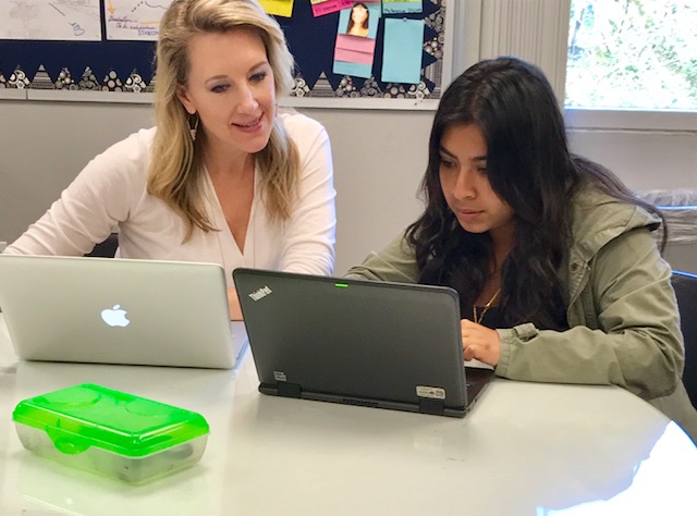 Khriseten helps a student revise an essay during a workshopping session