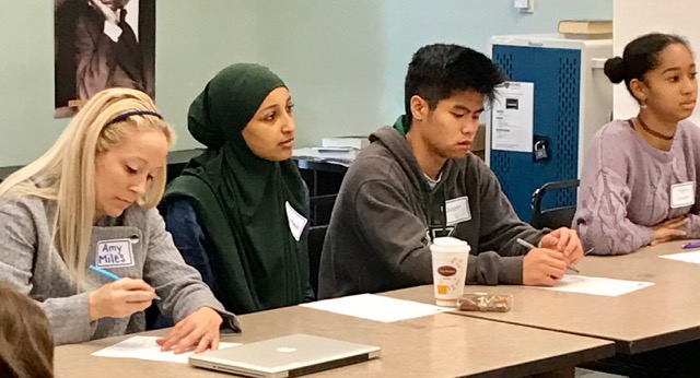 Khriseten's students engage in a round-table discussion during class