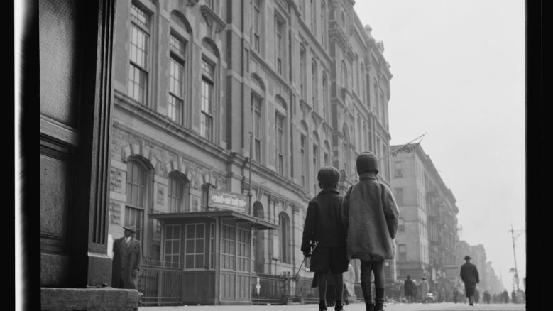 Black and white photograph titled, Harlem Scene (1943), depicting two children on the street in Harlem.