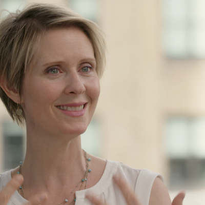 Portrait of Cynthia Nixon smiling.