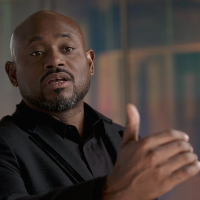 Portrait of Steve Stoute in mid-speech, hands gesturing.