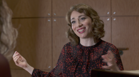 Portrait of Regina Spektor smiling and gesturing with hands.