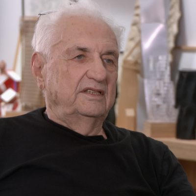 Portrait of Frank Gehry wearing a black top.