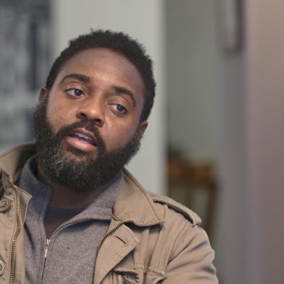 Portrait of Reginald Dwayne Betts in mid-speech.