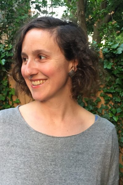 Headshot of Gillian Osborne smiling with head turned toward the left.