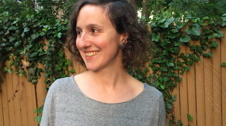 Headshot of Gillian Osborne smiling with head turned toward the left.