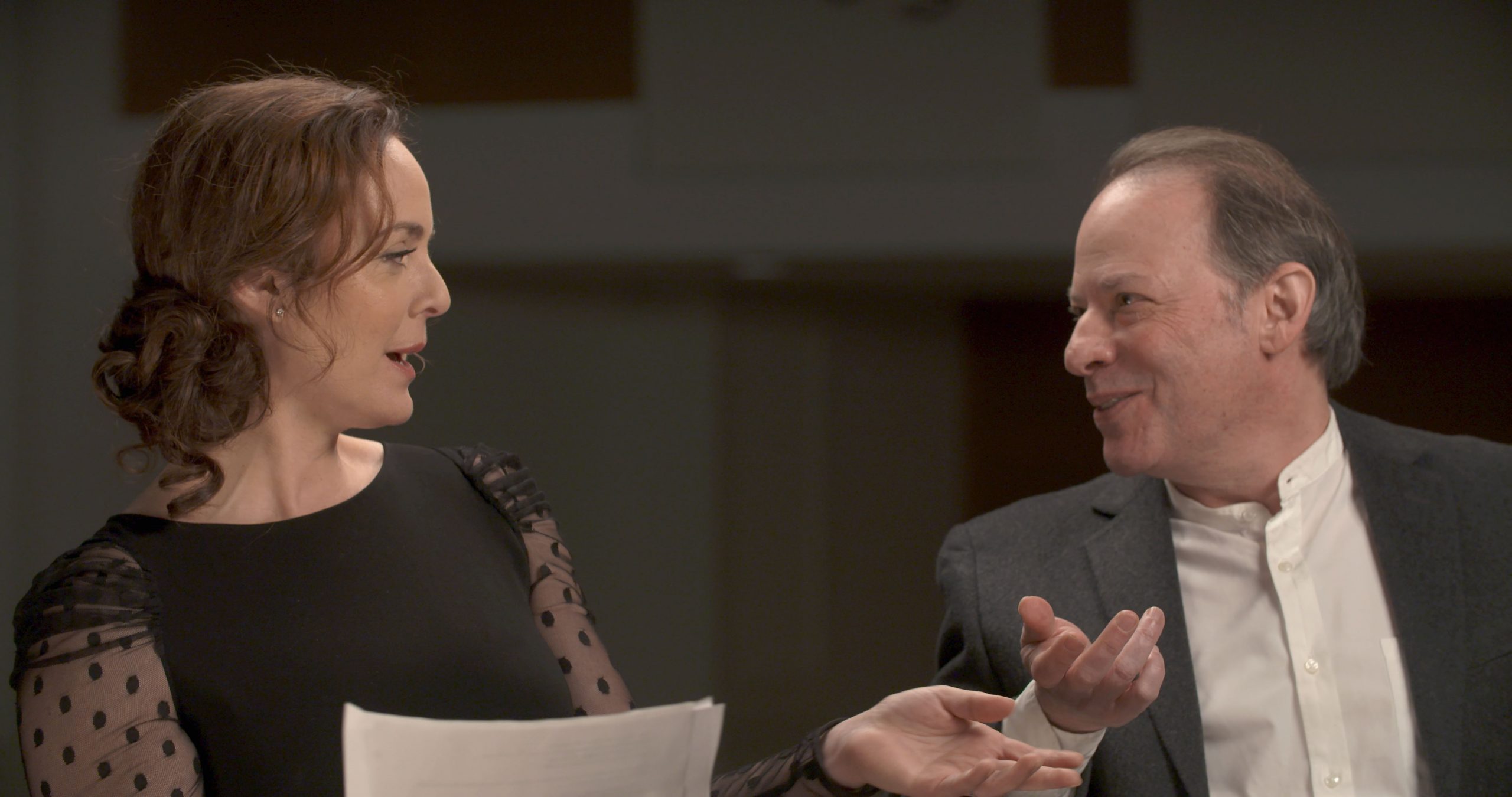 Melissa Errico on the left and Adam Gopnik on the right, in mid-conversation.