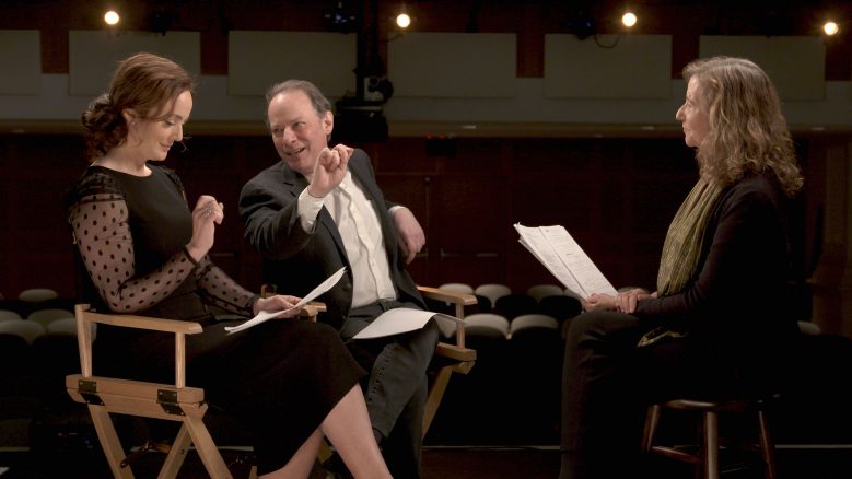 Melissa Errico, Adam Gopnik, and Elisa New seated and engaged in conversation with gesturing hands.