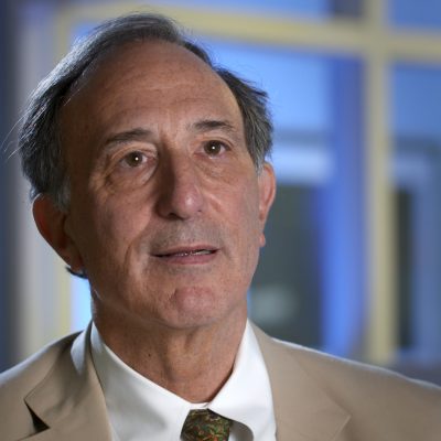 Portrait of Peter Seligmann wearing a suit and smiling