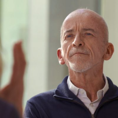 Portrait of Mark Doty in looking ahead, eyebrows furrowed.