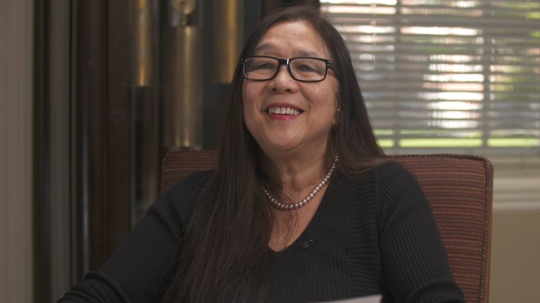 Portrait of Marilyn Chin wearing a black top and smiling.