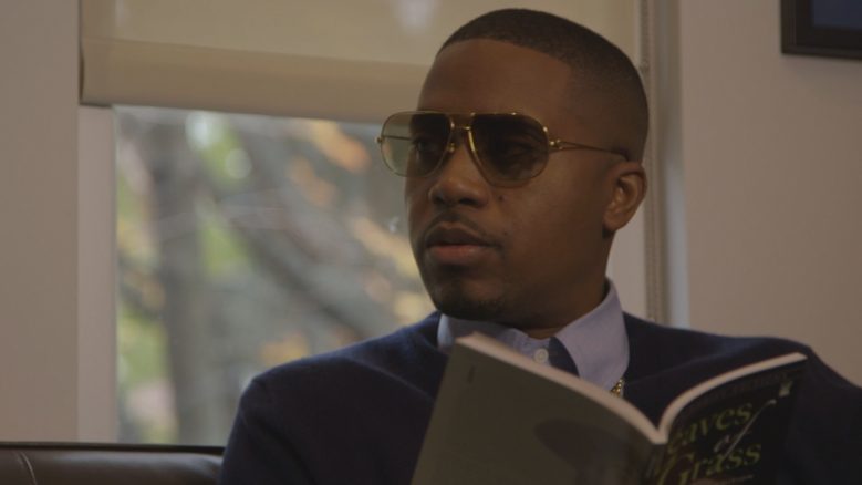 Hip Hop artist Nasir "Nas" Jones, wearing sunglasses and a suit.