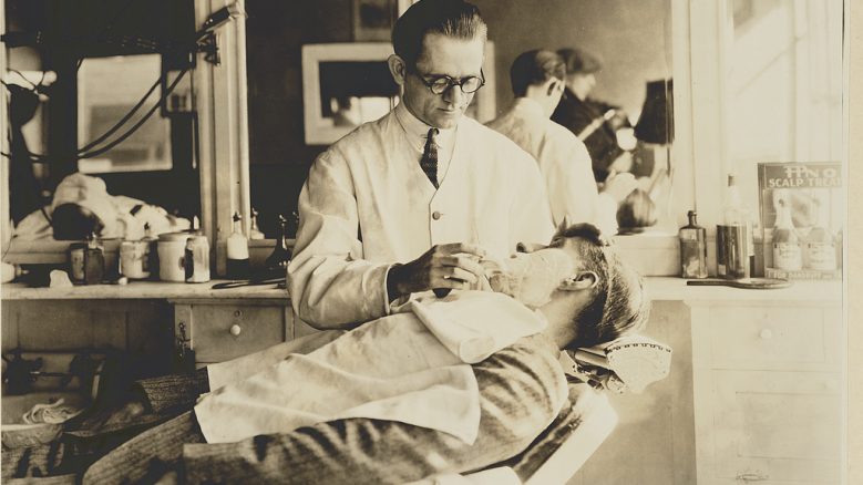 Photograph entitled "Barbershop Shave" shows a barber shaving a man's face.