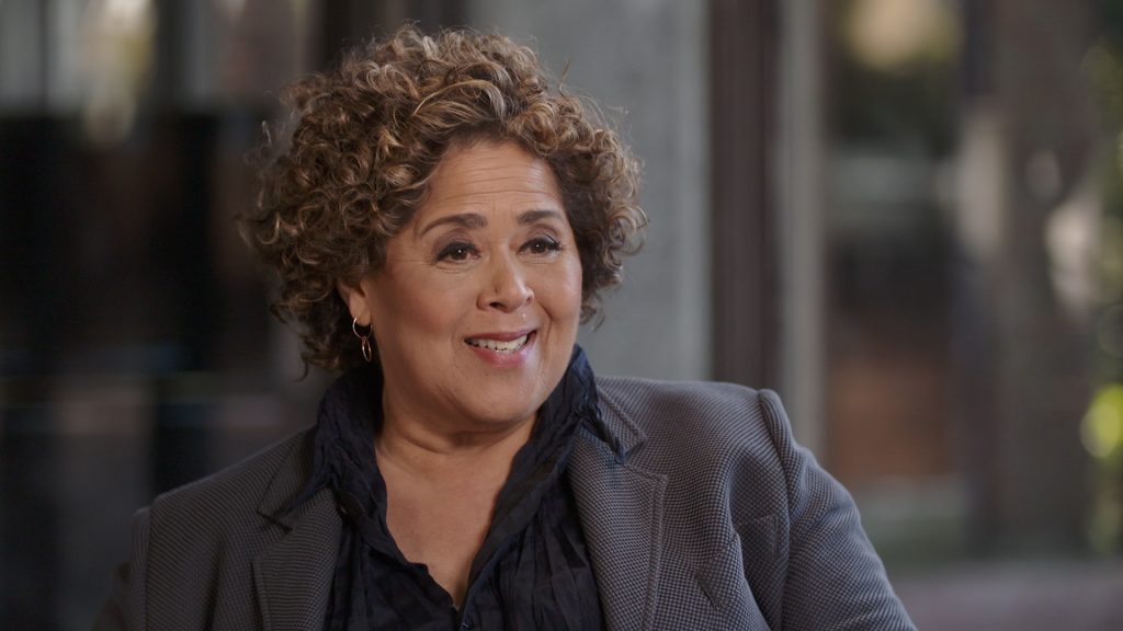 Anna Deveare Smith smiling in a gray blazer