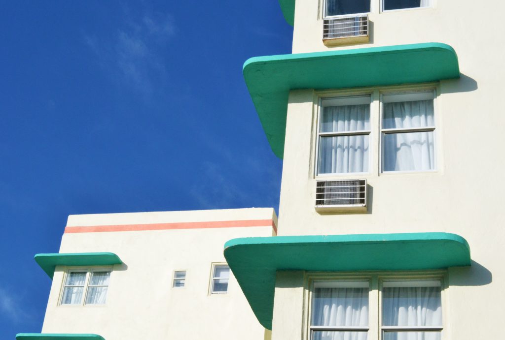 Close-up of a Miami Beach hotel with a blue sky backdrop.
