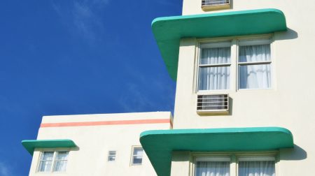 Close-up of a Miami Beach hotel with a blue sky backdrop.