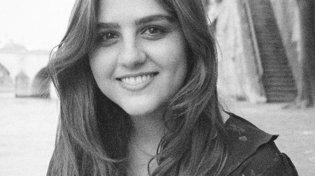 Black and white headshot of Camille Jacobson smiling