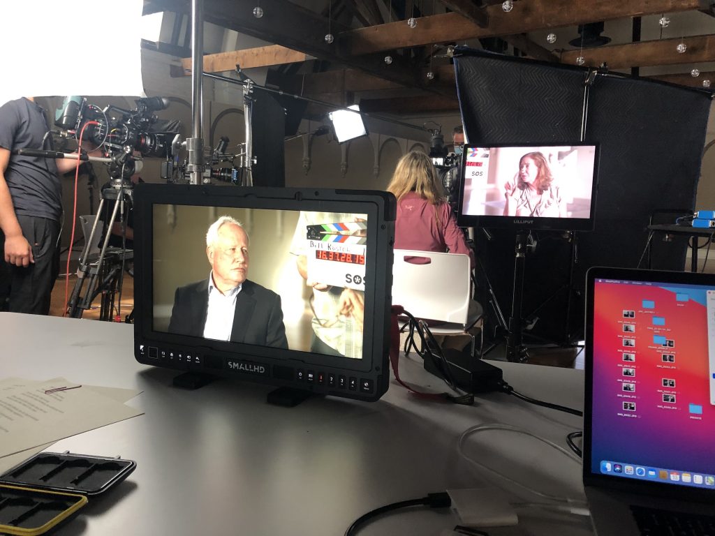 Elisa New and guest Bill Kristol on set at Planet Word Museum. 