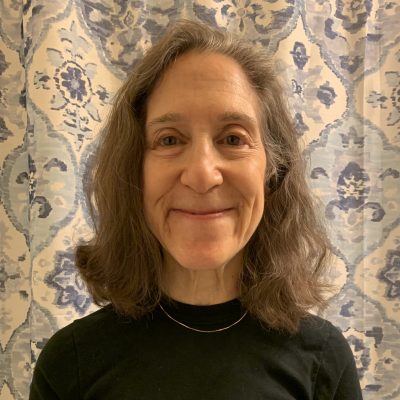 Portrait of Wendy Levine wearing a black top and smiling.