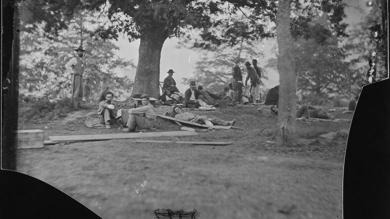 Photograph titled, “Wounded Soldiers under Trees, Marye’s Heights, Fredericksburg, after the Battle of Spotsylvania.”
