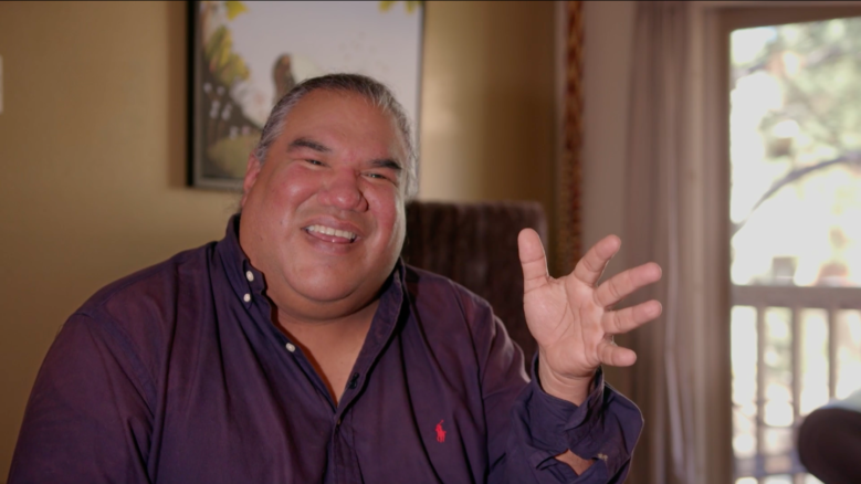 Filmmaker Chris Eyre, smiling while gesturing and in the middle of speaking