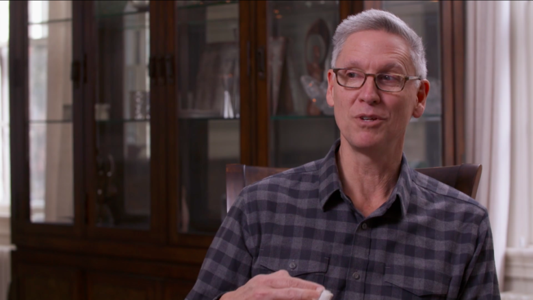 Historian Philip Deloria, wearing a button-up shirt, in the middle of speaking