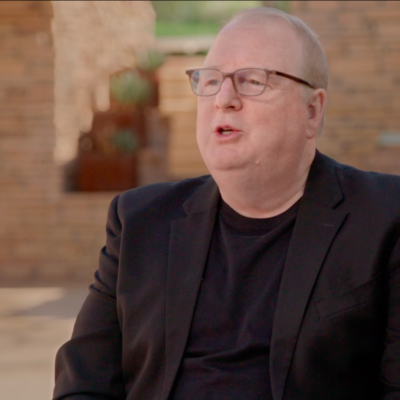 Jeffery Kennedy, wearing a suit, in the middle of speaking