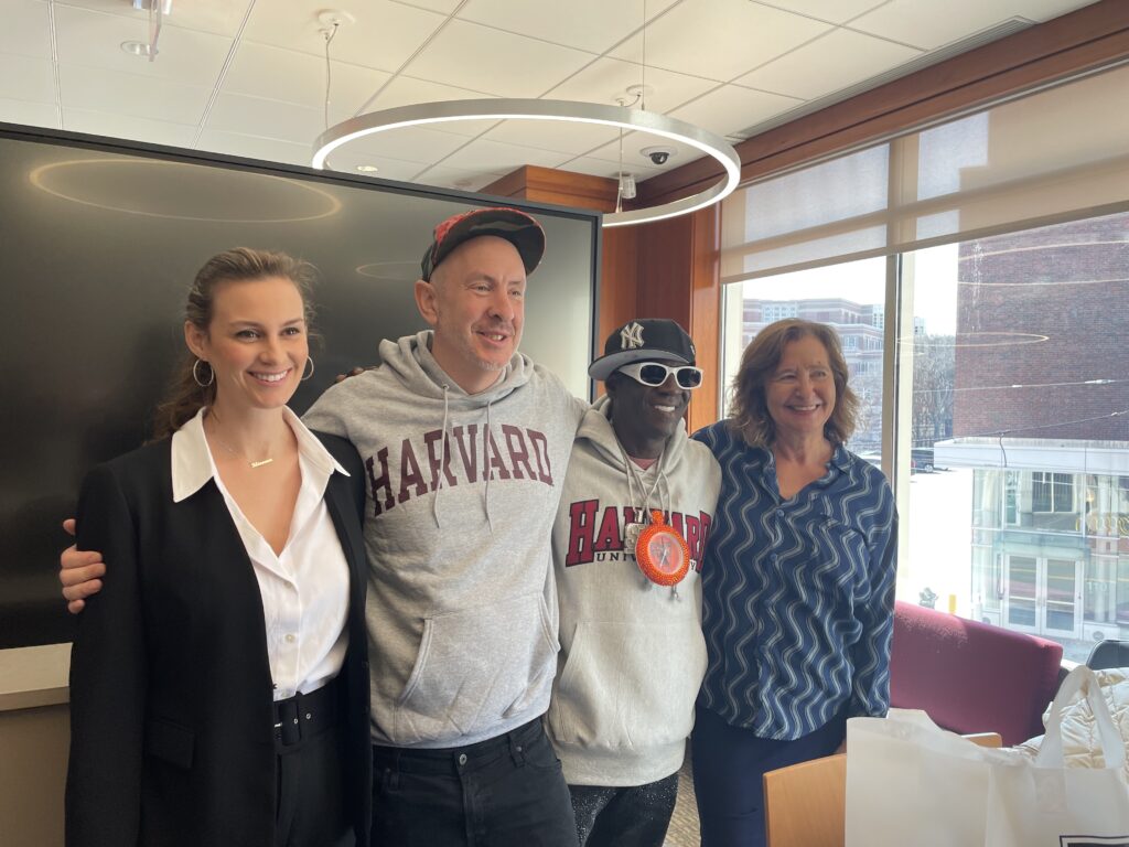 From left to right: talent manager Rhiannon Rae Ellis, songwriter Sam Hollander, rapper Flavor Flav, and professor Elisa New at Harvard Extension School. 