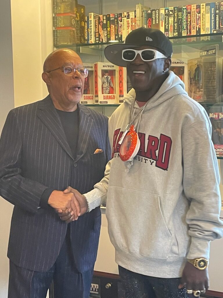 Flavor Flav shakes hand with fellow Poetry in America guest Henry Louis Gates, Jr.