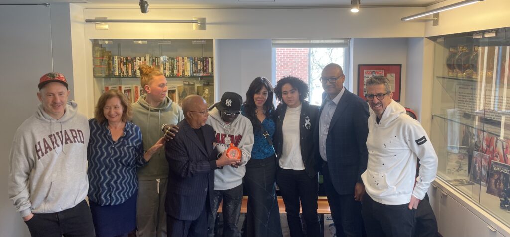 Flav donates an orange clock to the Harvard Hiphop Archive.