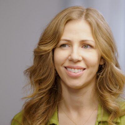 Rachael Price smiles while looking to the side