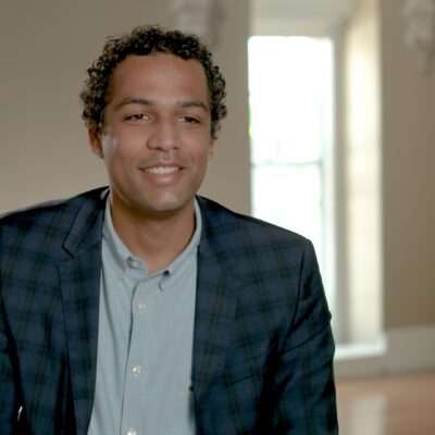 Justin Worland, wearing a suit, smiles