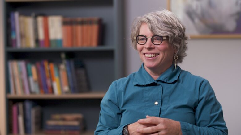 Jill Lepore smiles while wearing a teal button-up shirt