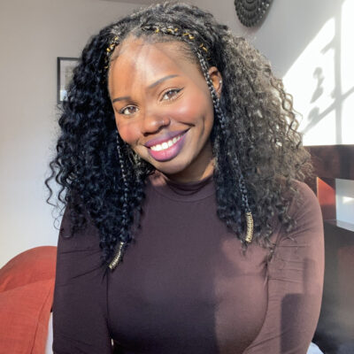 Suzannah Omonuk smiles while wearing a dark brown long sleeved shirt